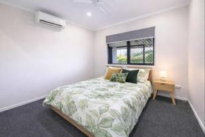 a white bedroom with a bed and a window at 4BR Family Home w Golf Course Views, BBQ & Secure Parking in Rosslea