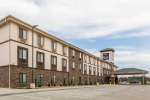 a large building with a parking lot in front of it at Sleep Inn & Suites O'Fallon MO - Technology Drive in O'Fallon