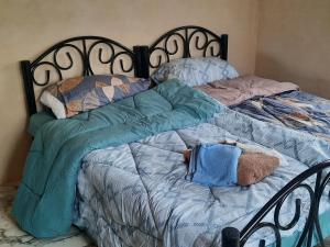 a bed with a stuffed animal laying on it at استراحة الباشا albash farm stay in Al Karāmah