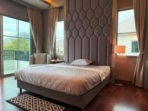a bedroom with a large bed and a large window at Luxury house for rent near Suvarnabhumi Airport in Sathani Lat Krabang +63 photos