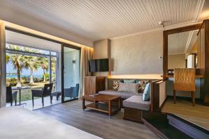 a bedroom with a bed and a living room at Shandrani Beachcomber Resort & Spa in Blue Bay +75 photos