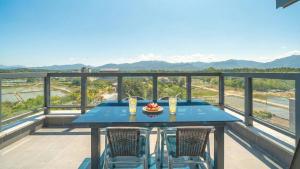 a blue table and chairs on a balcony with a view at goseong theprism pension in Goseong