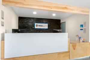 an office with a white counter and a brick wall at Clarion Pointe Prescott Valley in Prescott Valley