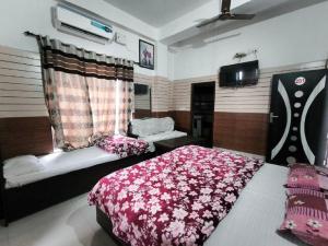 a bedroom with a bed and a tv in it at Arjun House Hotel- Guest House in Pathānkot