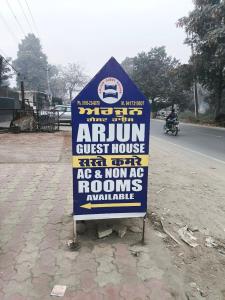 a sign sitting on the side of a road at Arjun House Hotel- Guest House in Pathānkot