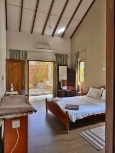 a bedroom with a bed and a large window at Mervins & Indus Residence in Colombo