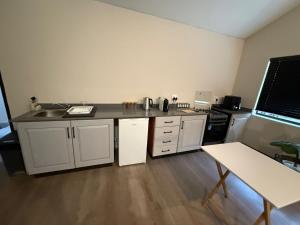 a kitchen with a sink and a counter top at Avo 2 on 27 Drew in Howick +5 photos