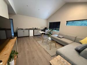 a living room with a couch and a table at Avo 2 on 27 Drew in Howick