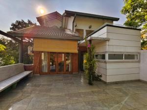 a house with a bench in front of it at Mervins & Indus Residence in Colombo