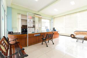 a waiting room with two chairs and a counter at Urbanview Hotel Bartu Moh Toha Bandung by RedDoorz in Bandung