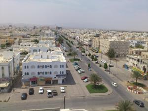 an aerial view of a city with buildings and cars at Husin Al Khaleej Hotel Apartment in Seeb