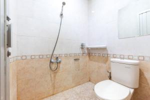 a bathroom with a toilet and a shower at Urbanview Hotel Bartu Moh Toha Bandung by RedDoorz in Bandung +26 photos