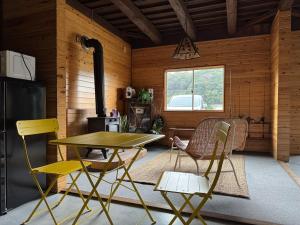 a kitchen with a table and chairs in a room at 海輪邸 in Shima