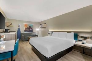 a hotel room with a large bed and a chair at Quality Inn Ruidoso in Ruidoso +22 photos