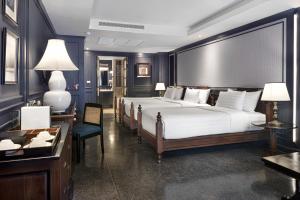 a hotel room with a large bed and a desk at Buri Sriping Riverside Resort & Spa in Chiang Mai +89 photos