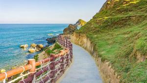 a retaining wall next to the ocean next to a cliff at Khách Sạn Nhơn Lý LYS HOTEL in Quy Nhon +55 photos