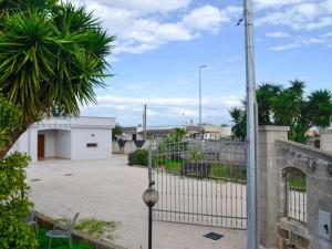 a fence with a gate in front of a building at Villa Alaya in Manduria