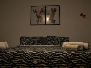 a bedroom with a bed with a teddy bear on it at Villa Alaya in Manduria +10 photos