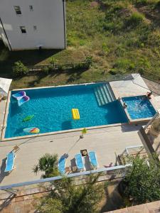 an overhead view of a swimming pool with two chairs and a swimming pool at Exclusive penthouse with stunning panoramic views in Prijevor