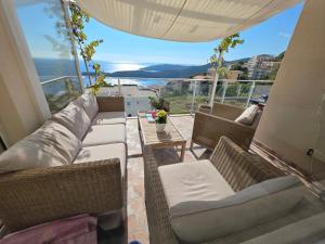 a living room with a couch and chairs on a balcony at Exclusive penthouse with stunning panoramic views in Prijevor