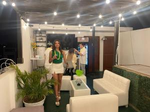 a woman walking through a room with people in it at Hostal Mirador in Pisco