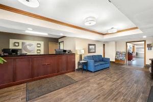 a living room with a blue chair and a couch at Comfort Inn Van Wert in Van Wert +37 photos
