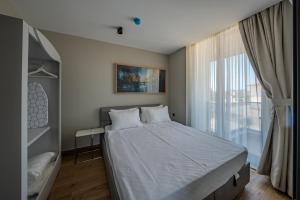 a bedroom with a bed and a large window at Moon Shine Apart in Altınkum +33 photos