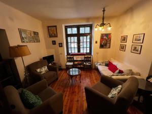 a living room with couches and a table at Ca' Il Guscio in Cortina dʼAmpezzo