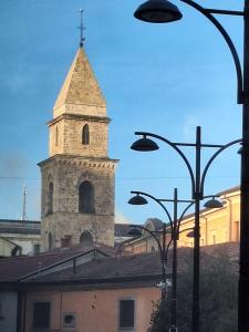 a church tower with a cross on top of a building at Pretoria Collection in Potenza