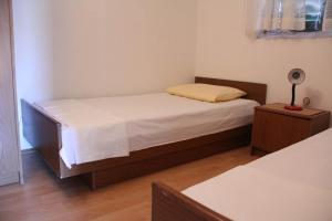 Postel nebo postele na pokoji v ubytování Apartments Kronja