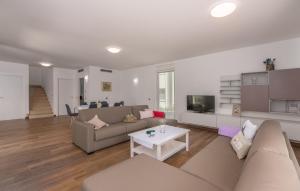a living room with a couch and a table at VILA PALISKA in Pula