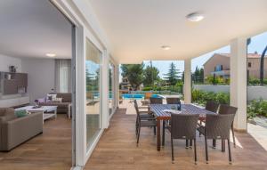 a dining room with a table and chairs at VILA PALISKA in Pula