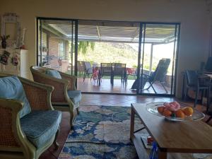a living room with a bowl of fruit on a table at Uitkyk Guest House in Fouriesburg +15 photos