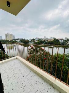 a balcony with a view of a body of water at Minimalhaven Stay in Vung Tau