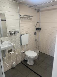 a bathroom with a toilet and a sink at Arabian Breeze in Tadri