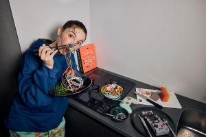 a young boy is playing with a wire instrument at Section L Akihabara in Tokyo