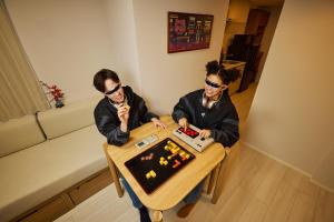 two people sitting at a table playing a game at Section L Akihabara in Tokyo +41 photos