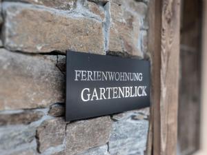 a sign on the side of a stone wall at Farmhouse in Schwendau with Ski Storage in Hippach