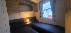 a small bedroom with a bed and a window at S & S Retreat in Heysham +32 photos