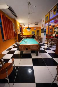a room with a pool table on a checkered floor at Sunflower Beach Backpacker Hostel & Bar in Rimini