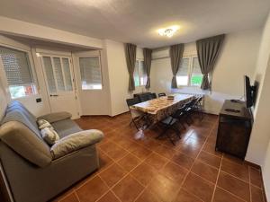 a living room with a couch and a table at Casa Rural Villa Ribatejada in Ribatejada