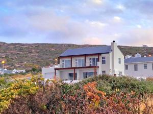 a house on the side of a hill at West Coast Rock in St. Helena Bay