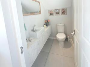 a white bathroom with a sink and a toilet at West Coast Rock in St. Helena Bay +31 photos