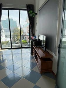 a room with a tiled floor with a large window at TH Homestay in Danang