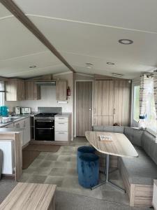 a kitchen with a couch and a table in it at S & S Retreat in Heysham