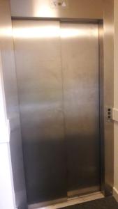 a metal elevator in a building with its door open at Alton Apartments in Bradford