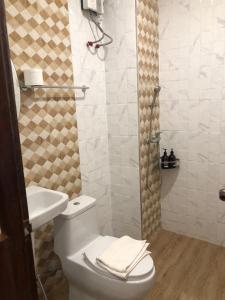 a bathroom with a toilet and a sink and a shower at Chiangkhan Hotel in Chiang Khan +59 photos