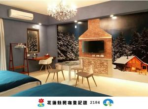 a bedroom with a fireplace and a tv on a wall at Happiness 1799 幸福有約1799民宿電梯花蓮火車站東出口 - 證號 2184-English welcome in Hualien City