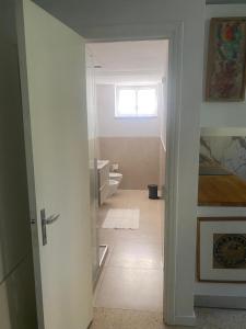 a bathroom with a toilet and a window at da Melina in Parma
