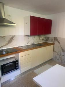 a kitchen with a sink and a microwave at da Melina in Parma +4 photos